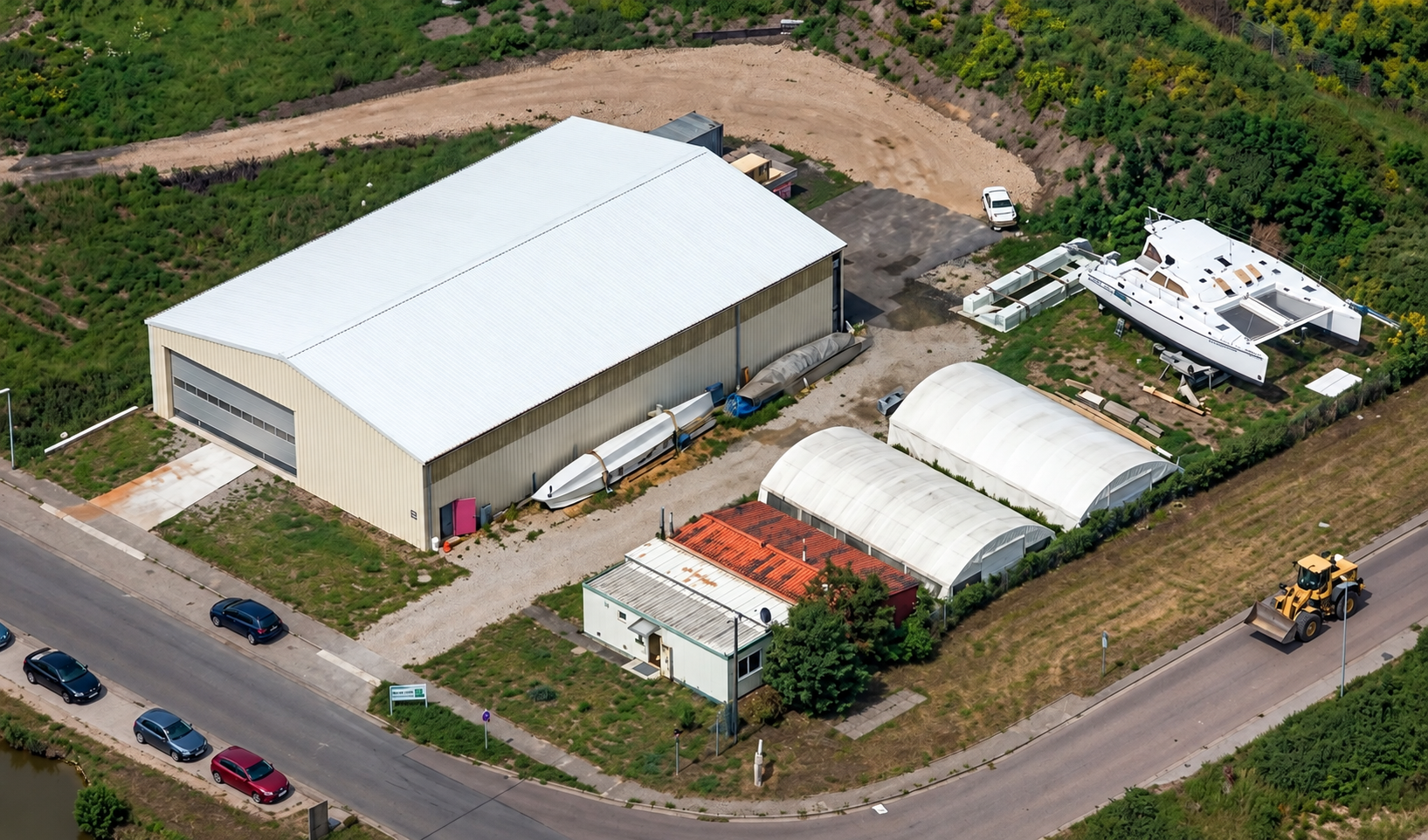 Aerial view of the catamaran boatyard in Roßlau with workshop and catamarans.