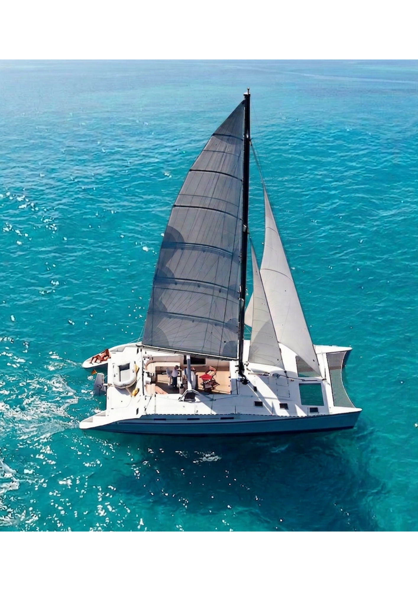 KatManDu catamaran viewed from above on turquoise water.